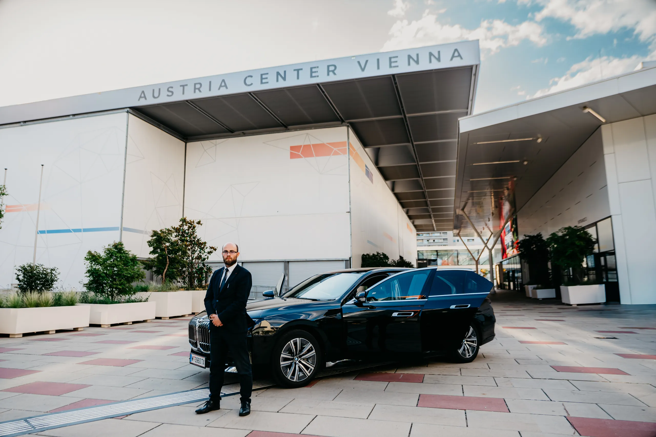 Chauffeur vor dem BMW i7 am Austria Center Vienna