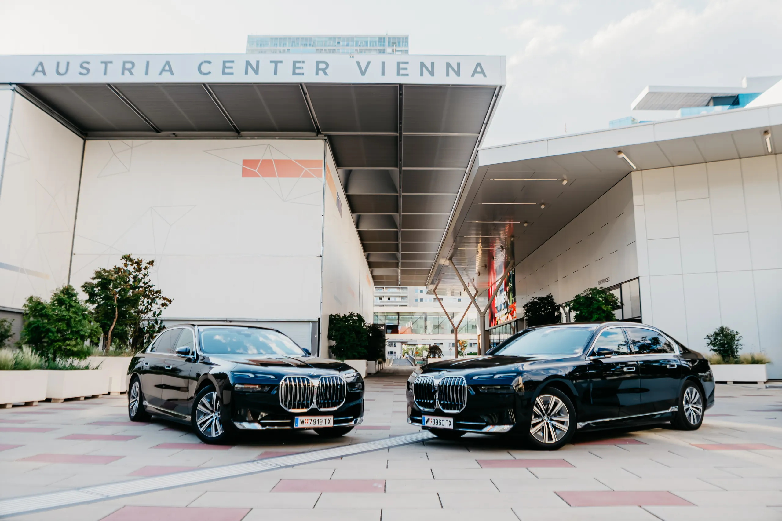 Zwei BMW i7 frontal nebeneinander vor dem Austria Center Vienna